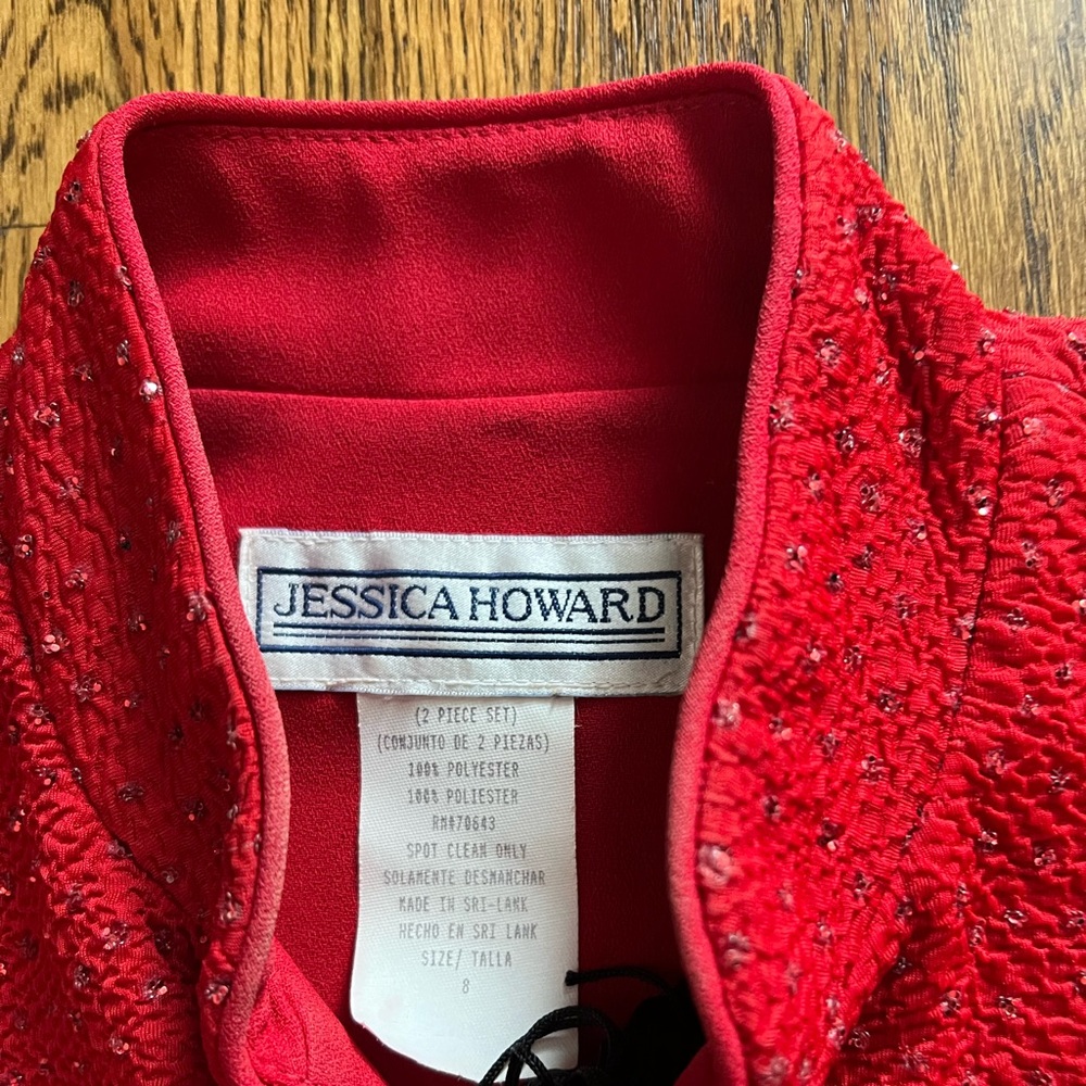 Sparkly red zippered top with black pants.